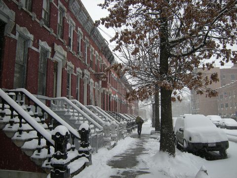 Row houses on East 139th Street in falling snow